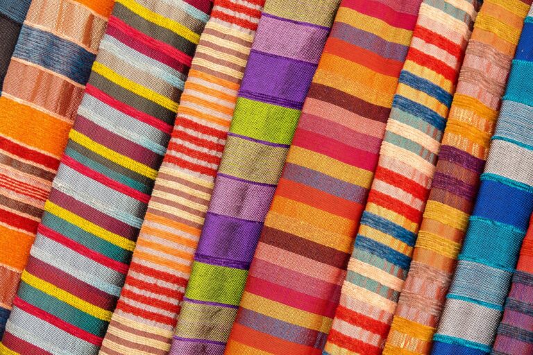 Colorful striped textiles arranged in a vibrant, artistic display, perfect for design inspiration.