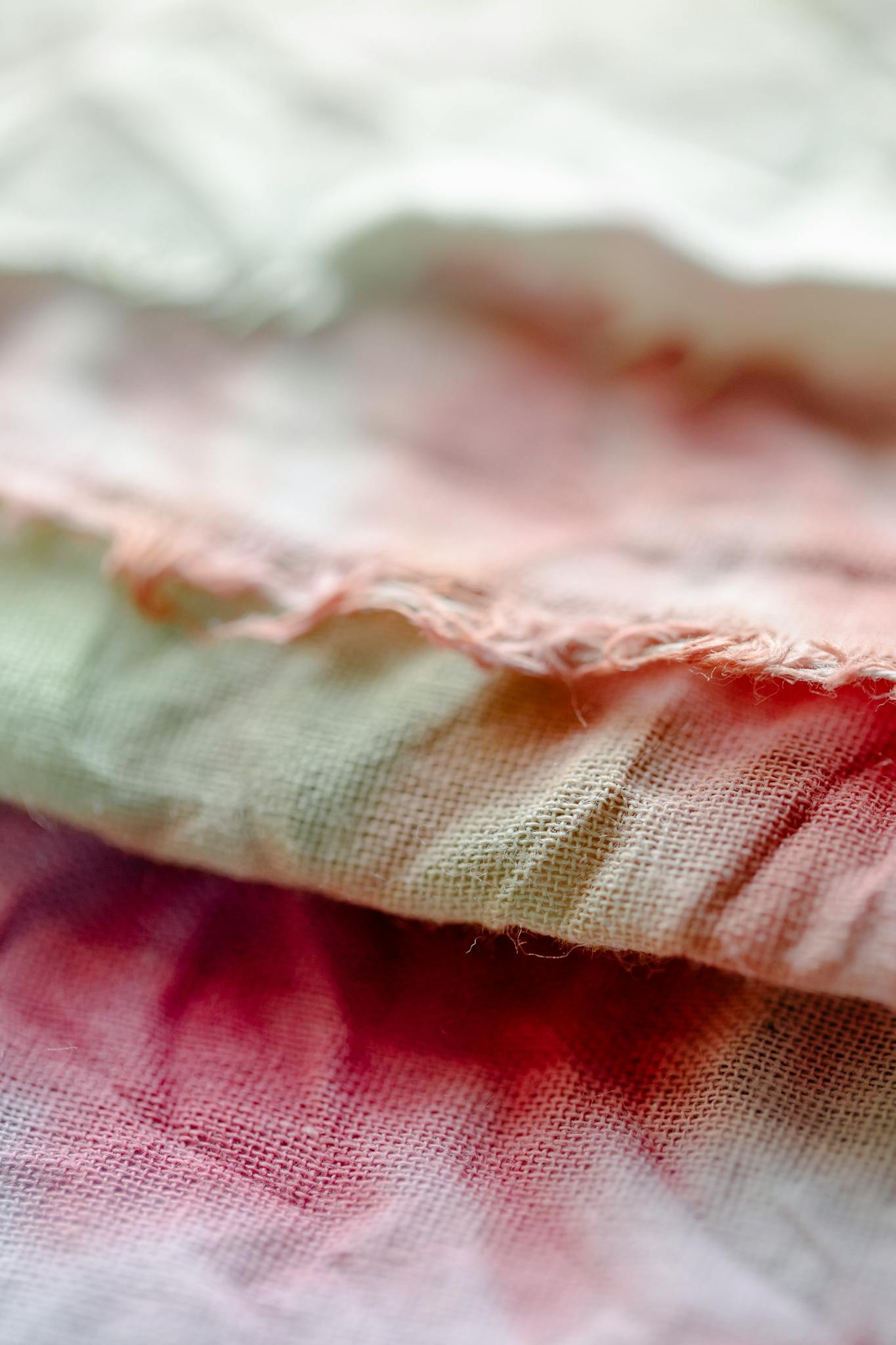 Detailed close-up of vibrant tie-dye cotton textiles with soft focus showcasing fabric texture.