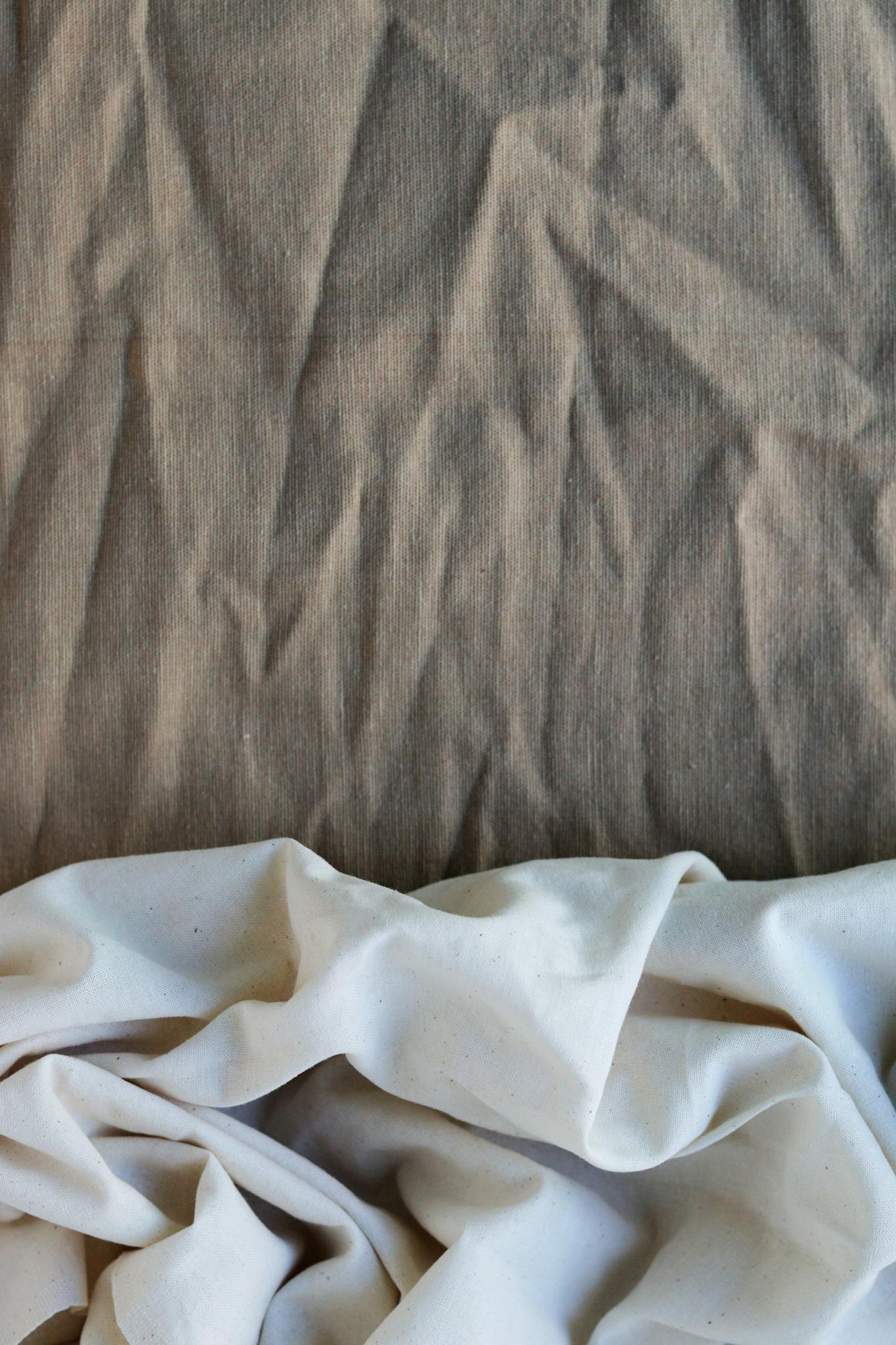 High-quality close-up of natural linen and cotton fabrics with textural details.